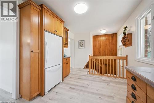 Light wood-finish flooring complements the natural wood cabinetry and built-in refrigerator - 27 Silverspring Crescent, Kitchener, ON - Indoor Photo Showing Other Room