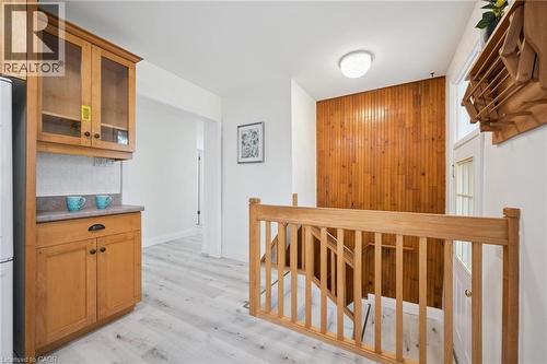 Hardwood staircase with vertical wood paneling - 27 Silverspring Crescent, Kitchener, ON - Indoor Photo Showing Other Room