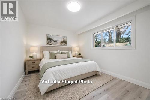 Bright room with a large window featuring white trim and a recessed ceiling light - 27 Silverspring Crescent, Kitchener, ON - Indoor Photo Showing Bedroom