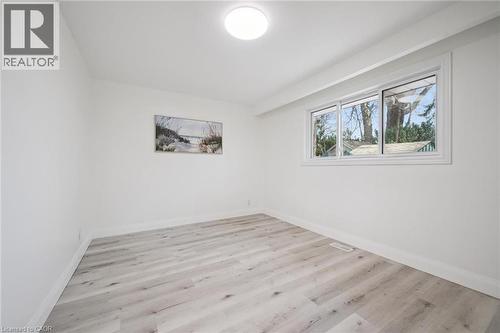 Interior room featuring light wood-finish flooring, white walls, and a multi-pane window with white trim - 27 Silverspring Crescent, Kitchener, ON - Indoor Photo Showing Other Room
