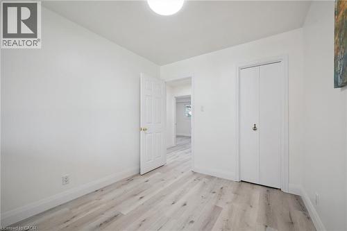 Room featuring light wood-finish flooring, white walls, and a flush-mount ceiling light - 27 Silverspring Crescent, Kitchener, ON - Indoor Photo Showing Other Room