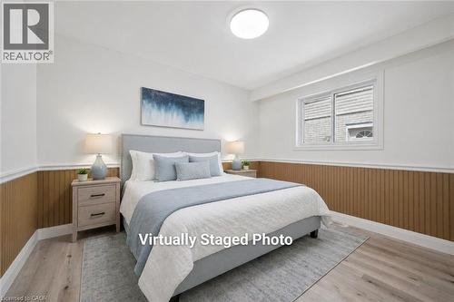 Bedroom featuring wood-finish flooring, white walls, and a window with white trim - 27 Silverspring Crescent, Kitchener, ON - Indoor Photo Showing Bedroom