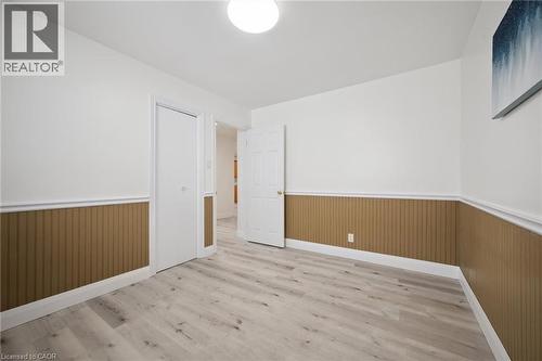 Interior room featuring light wood-finish flooring, white walls, and beadboard wainscoting - 27 Silverspring Crescent, Kitchener, ON - Indoor Photo Showing Other Room