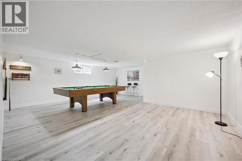 Spacious recreation room featuring light wood-finish flooring, white walls, and a white ceiling - 27 Silverspring Crescent, Kitchener, ON - Indoor Photo Showing Other Room
