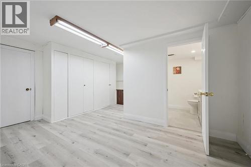 Room featuring light wood-finish flooring, white walls, and built-in white cabinetry - 27 Silverspring Crescent, Kitchener, ON - Indoor Photo Showing Other Room