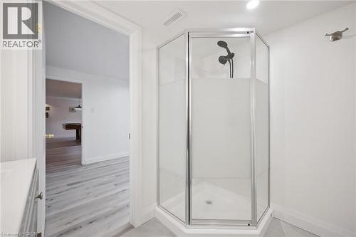 Corner glass-enclosed shower with matte black fixtures and a tile base - 27 Silverspring Crescent, Kitchener, ON - Indoor Photo Showing Bathroom