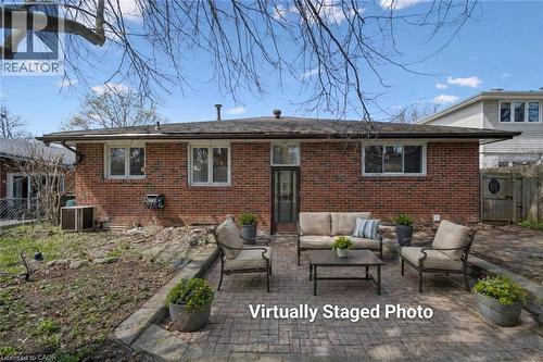 Brick exterior featuring multiple windows and a glass-paneled door - 27 Silverspring Crescent, Kitchener, ON - Outdoor With Deck Patio Veranda With Exterior