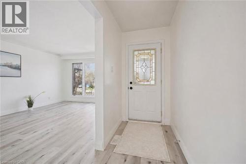 Entryway featuring a white door with a leaded glass insert, light wood-finish flooring, and white walls - 27 Silverspring Crescent, Kitchener, ON - Indoor Photo Showing Other Room