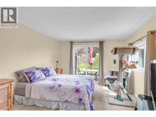 Primary bedroom. So bright with the sliding glass door leading to a cute deck and backyard. - 12022 Pretty Road Unit# 16, Lake Country, BC 