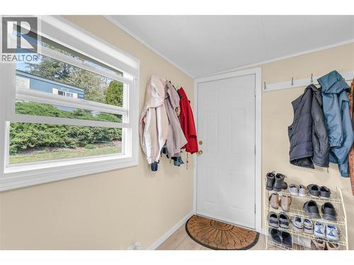 Den or mud room with a door to access the back yard and workshop. - 12022 Pretty Road Unit# 16, Lake Country, BC 