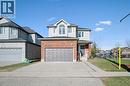 Traditional home with brick siding, a garage, and concrete driveway - 649 Doon South Drive, Kitchener, ON  - Outdoor 