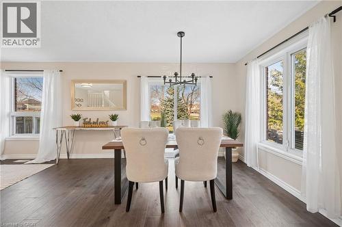 Dining space with dark wood-type flooring and hanging lights - 649 Doon South Drive, Kitchener, ON - Indoor Photo Showing Dining Room