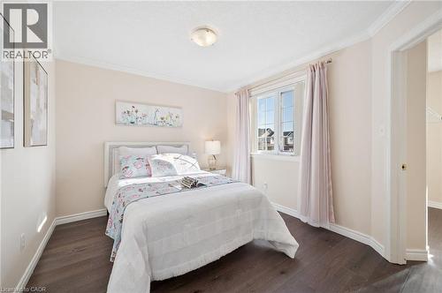 Bedroom with dark wood-type flooring and crown molding - 649 Doon South Drive, Kitchener, ON - Indoor Photo Showing Bedroom