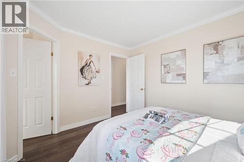 Bedroom with crown molding and dark wood-type flooring - 649 Doon South Drive, Kitchener, ON - Indoor Photo Showing Bedroom