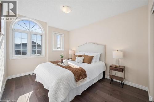 Bedroom featuring dark wood-style flooring and baseboards - 649 Doon South Drive, Kitchener, ON - Indoor Photo Showing Bedroom