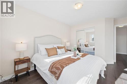 Bedroom featuring a closet and dark wood-type flooring - 649 Doon South Drive, Kitchener, ON - Indoor Photo Showing Bedroom