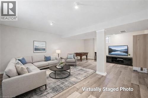 Living area featuring light wood-style flooring and baseboards - 649 Doon South Drive, Kitchener, ON - Indoor Photo Showing Living Room