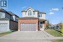 Traditional home with brick siding, asphalt driveway, a front lawn, and an attached garage - 649 Doon South Drive, Kitchener, ON  - Outdoor 