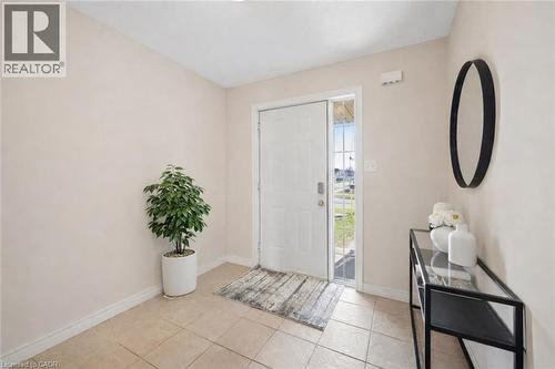 Entrance foyer with baseboards and light tile patterned floors - 649 Doon South Drive, Kitchener, ON - Indoor Photo Showing Other Room