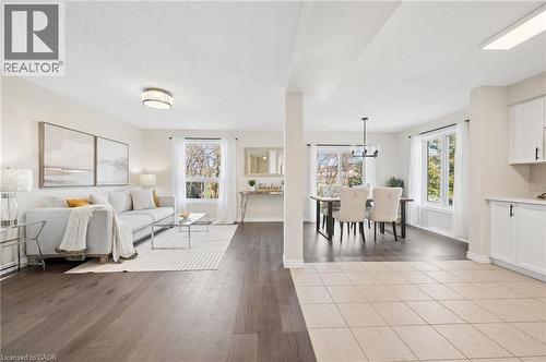 Living area with light wood-style flooring and baseboards - 649 Doon South Drive, Kitchener, ON - Indoor