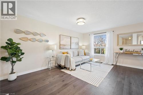 Living room with baseboards and dark wood-type flooring - 649 Doon South Drive, Kitchener, ON - Indoor Photo Showing Bedroom