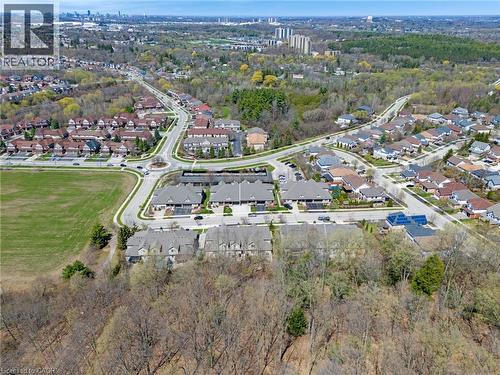 Expansive aerial landscape featuring a residential neighborhood with varied housing styles, established tree lines, a circular intersection, and open green spaces - 227 Chestnut Hill Crescent, Kitchener, ON - Outdoor With View