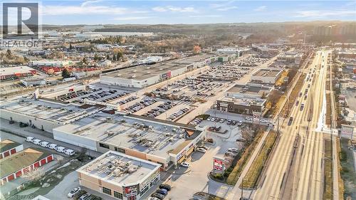 Aerial perspective showcasing commercial properties with extensive parking facilities - 589 Fairway Road S, Kitchener, ON 