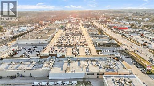 Expansive commercial property featuring multiple interconnected buildings, extensive surface parking areas, and convenient roadway frontage - 589 Fairway Road S, Kitchener, ON 