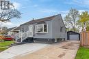 Gray siding exterior with a prominent bay window, white entry door, and concrete driveway - 36 Mahony Avenue, Hamilton, ON  - Outdoor 