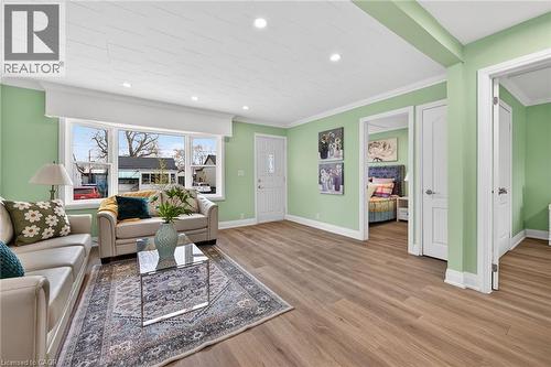 Bright living space featuring wood-finish flooring and recessed lighting - 36 Mahony Avenue, Hamilton, ON - Indoor Photo Showing Living Room