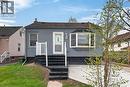 Exterior featuring gray horizontal siding, a dark shingle roof, and a bay window - 36 Mahony Avenue, Hamilton, ON  - Outdoor 