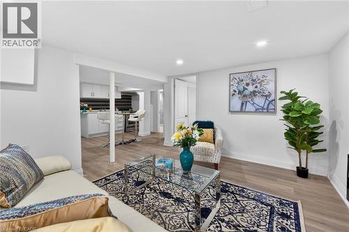 Open-concept living space featuring wood-finish flooring, recessed lighting, and a white interior paint scheme - 36 Mahony Avenue, Hamilton, ON - Indoor