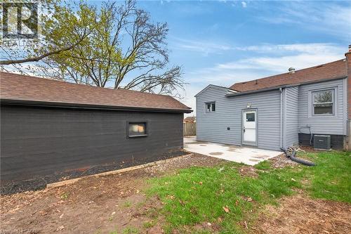 Detached garage with dark painted brick exterior and brown shingle roof - 36 Mahony Avenue, Hamilton, ON - Outdoor