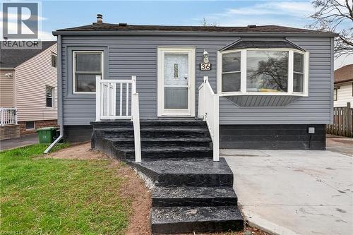 Gray siding exterior with a bay window and a concrete driveway - 36 Mahony Avenue, Hamilton, ON - Outdoor