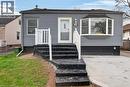 Gray siding exterior with a bay window and a concrete driveway - 36 Mahony Avenue, Hamilton, ON  - Outdoor 