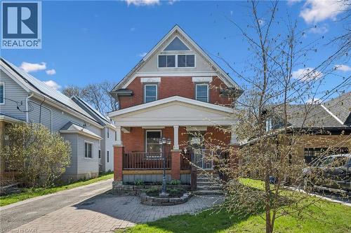 Brick exterior with a prominent front porch, white columns, and a pediment-style roofline - 115 Allen Street E, Waterloo, ON - Outdoor With Deck Patio Veranda
