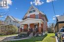 Brick exterior with a covered front porch featuring white columns and a dark railing - 115 Allen Street E, Waterloo, ON  - Outdoor With Deck Patio Veranda 