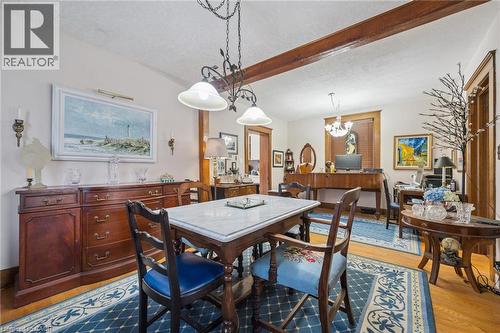 Dining area featuring a marble-topped table, wood-finish flooring, and exposed wood beam accents - 115 Allen Street E, Waterloo, ON - Indoor Photo Showing Dining Room