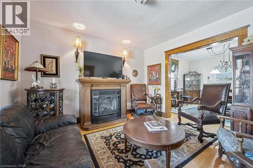 Living room featuring a wood-finish fireplace mantel and a decorative fireplace insert - 115 Allen Street E, Waterloo, ON - Indoor Photo Showing Living Room With Fireplace