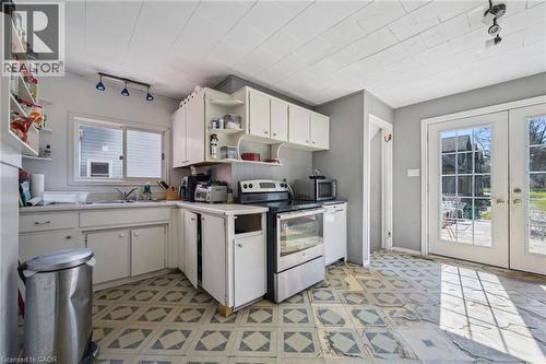 Kitchen featuring white cabinetry, a stainless steel range, and a dual-basin sink - 115 Allen Street E, Waterloo, ON - Indoor Photo Showing Kitchen With Double Sink