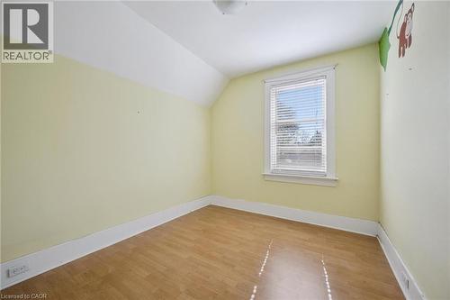 Room featuring wood-finish flooring, a single window with blinds, and light-colored walls - 115 Allen Street E, Waterloo, ON - Indoor Photo Showing Other Room