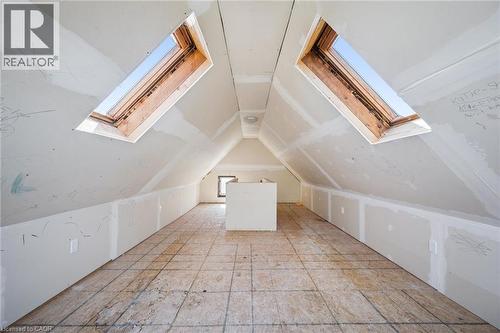 Spacious attic room with exposed plywood subflooring, two prominent skylights, and a recessed window - 115 Allen Street E, Waterloo, ON - Indoor Photo Showing Other Room