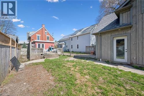 Rear exterior featuring a spacious wooden deck with railings, offering direct access to the interior via double glass doors - 115 Allen Street E, Waterloo, ON - Outdoor With Exterior