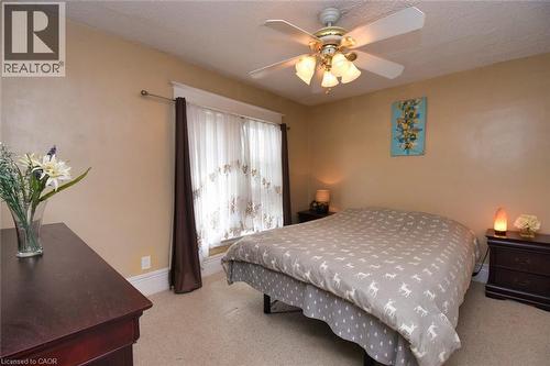 Bedroom featuring a ceiling fan with integrated lighting, window with decorative curtains, and light-toned wall paint - 522 Aberdeen Avenue, Hamilton, ON - Indoor Photo Showing Bedroom