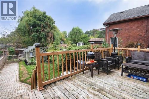 Spacious wood-finish deck with natural wood railings, overlooking a paved walkway and a detached shed - 522 Aberdeen Avenue, Hamilton, ON - Outdoor With Deck Patio Veranda With Exterior