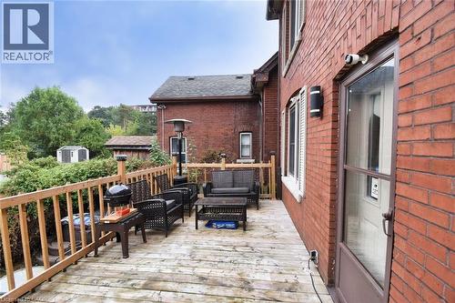 Exterior brick construction with a wood deck featuring a natural wood railing - 522 Aberdeen Avenue, Hamilton, ON - Outdoor With Deck Patio Veranda With Exterior