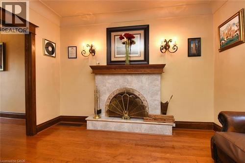 Fireplace featuring a wood mantel, tiled surround, and hearth - 522 Aberdeen Avenue, Hamilton, ON - Indoor With Fireplace