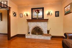 Fireplace featuring a wood mantel, tiled surround, and hearth - 