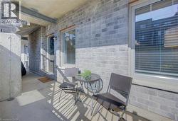 Exterior patio with concrete flooring, framed by light gray brickwork - 
