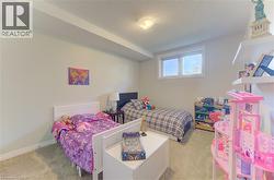 Neutral wall paint, light-colored carpet flooring, recessed window, and ceiling-mounted light fixture - 